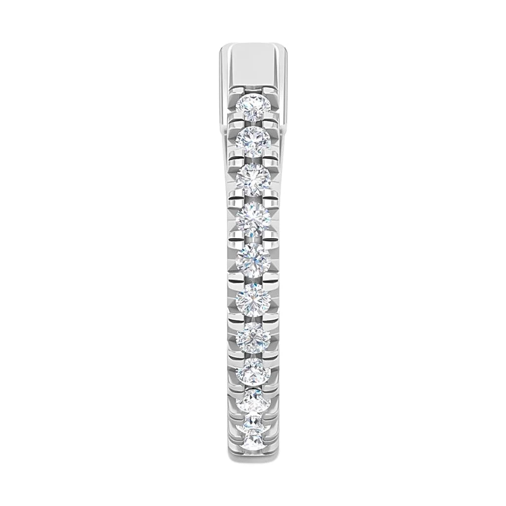 A white gold ring with a row of small round diamonds set along the top half of the band.