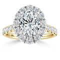 Gold ring with large oval center diamond, halo of round diamonds, and diamond accents on the band.