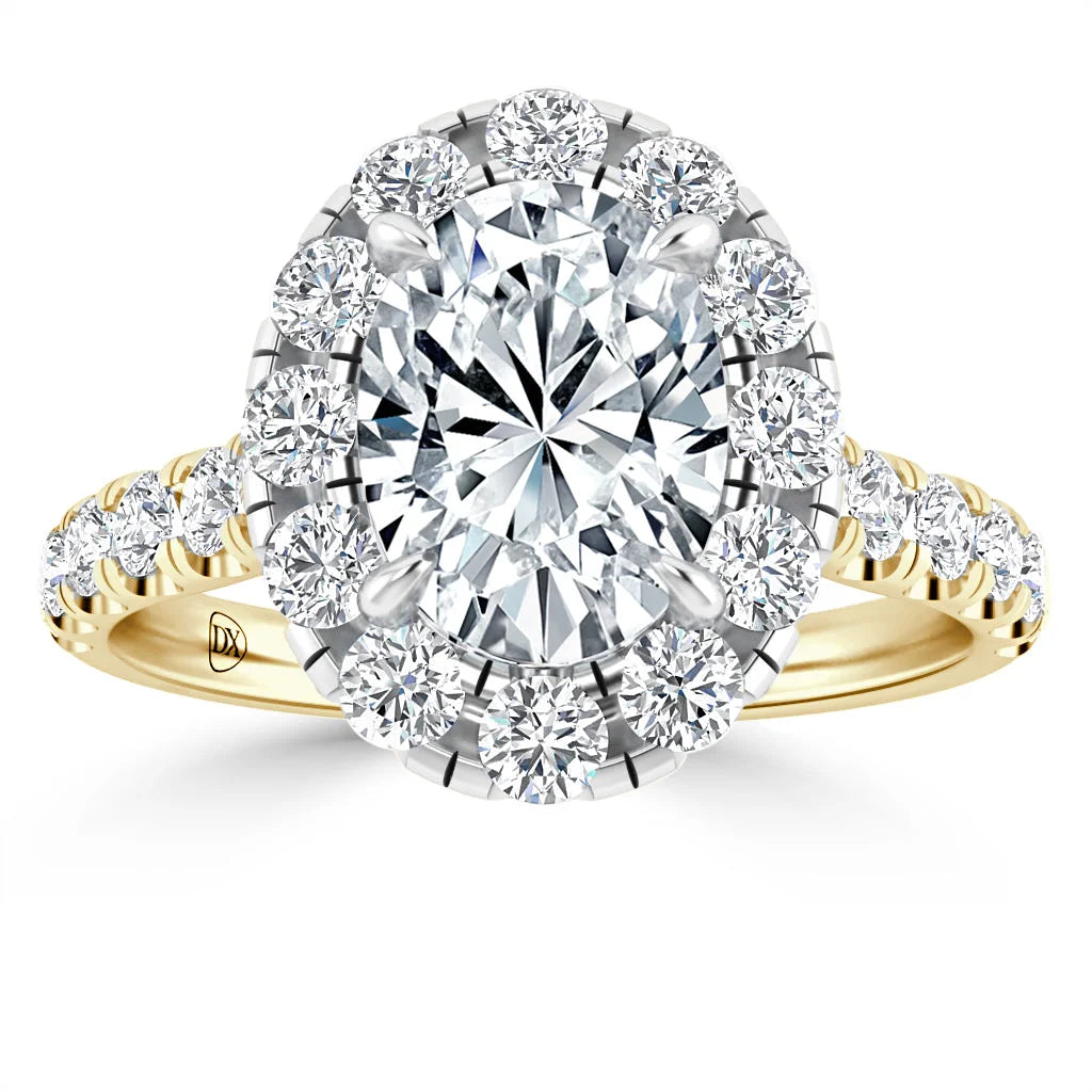 Gold ring with large oval center diamond, halo of round diamonds, and diamond accents on the band.