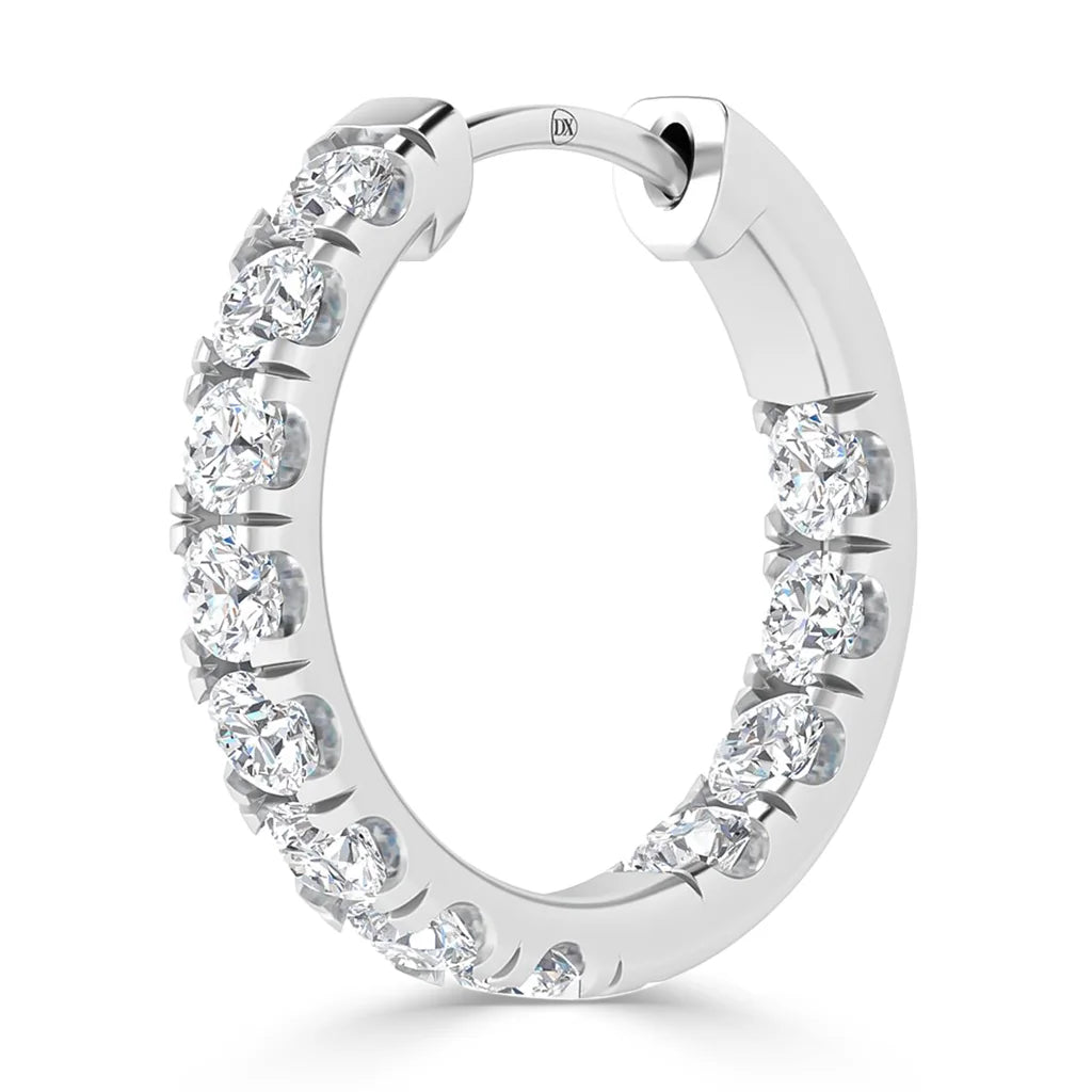 A silver hoop earring adorned with round, sparkling white diamonds set along the outer edge.