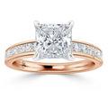 Rose gold ring with a large princess-cut diamond and channel-set diamonds along the band.