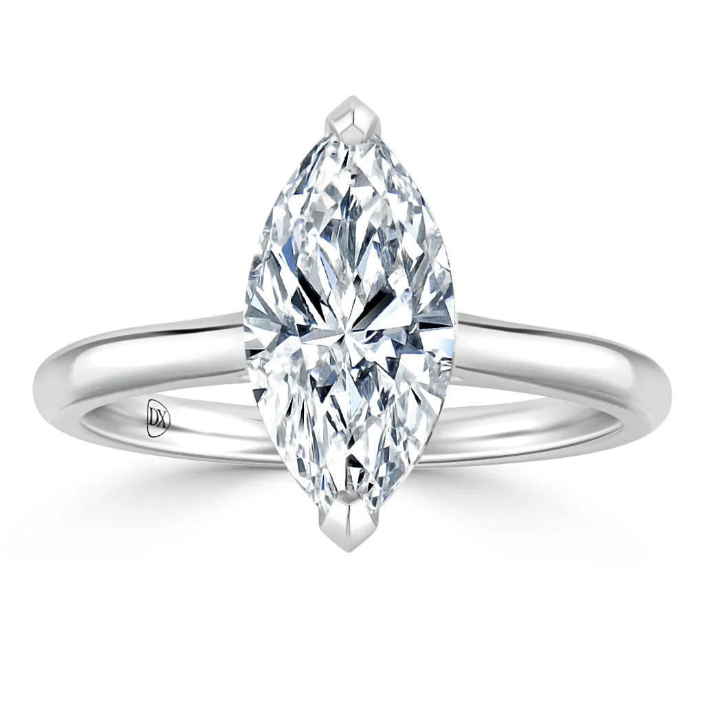 A marquise-cut diamond solitaire ring with a thin, polished white gold band on a white background.