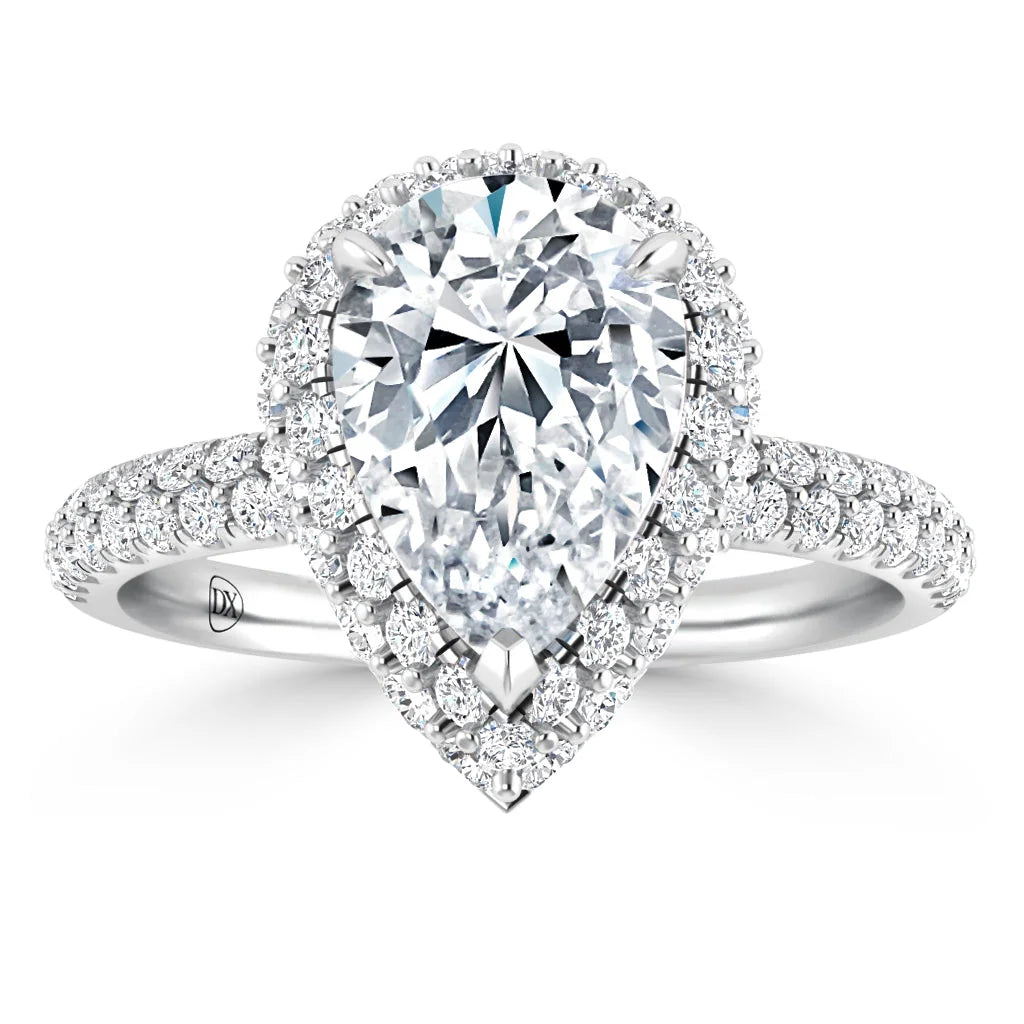 Pear-shaped diamond ring with a double halo and pavé diamond band, set in white gold, on a white background.