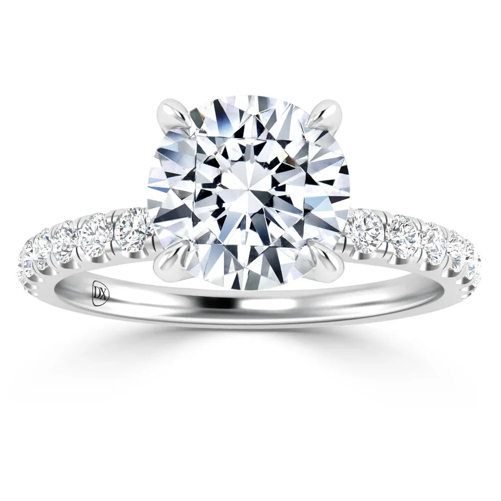 A round-cut diamond ring with side stones set in a silver band, viewed from the front.