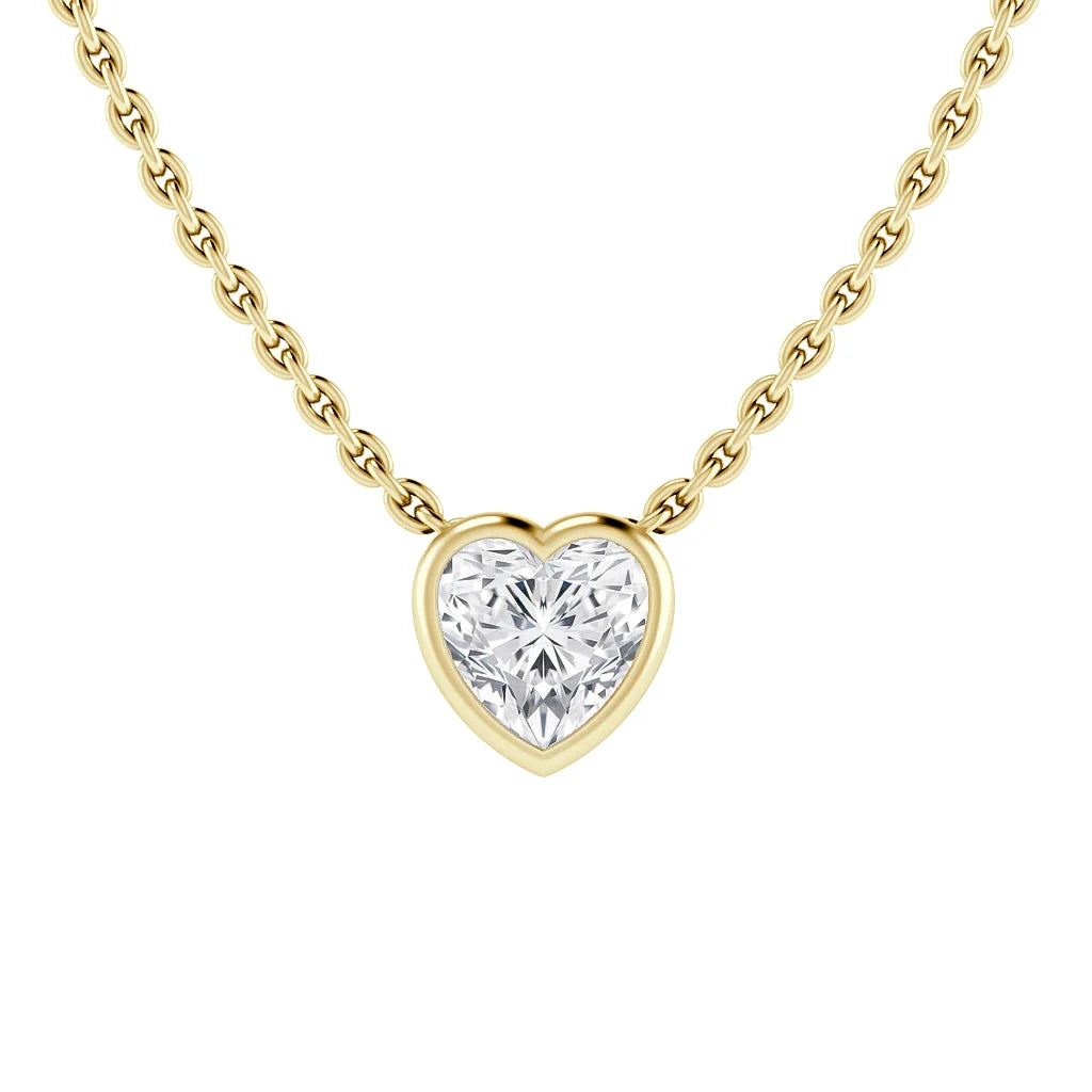Gold chain necklace with a heart-shaped diamond pendant, set in a gold frame, on a white background.