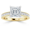 Gold ring with a large square-cut diamond center and smaller diamonds set along the band.