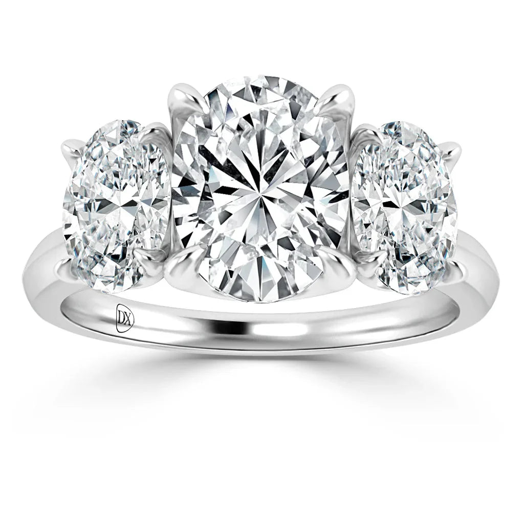 Platinum ring with three oval-cut diamonds; a large center stone and two smaller side stones.