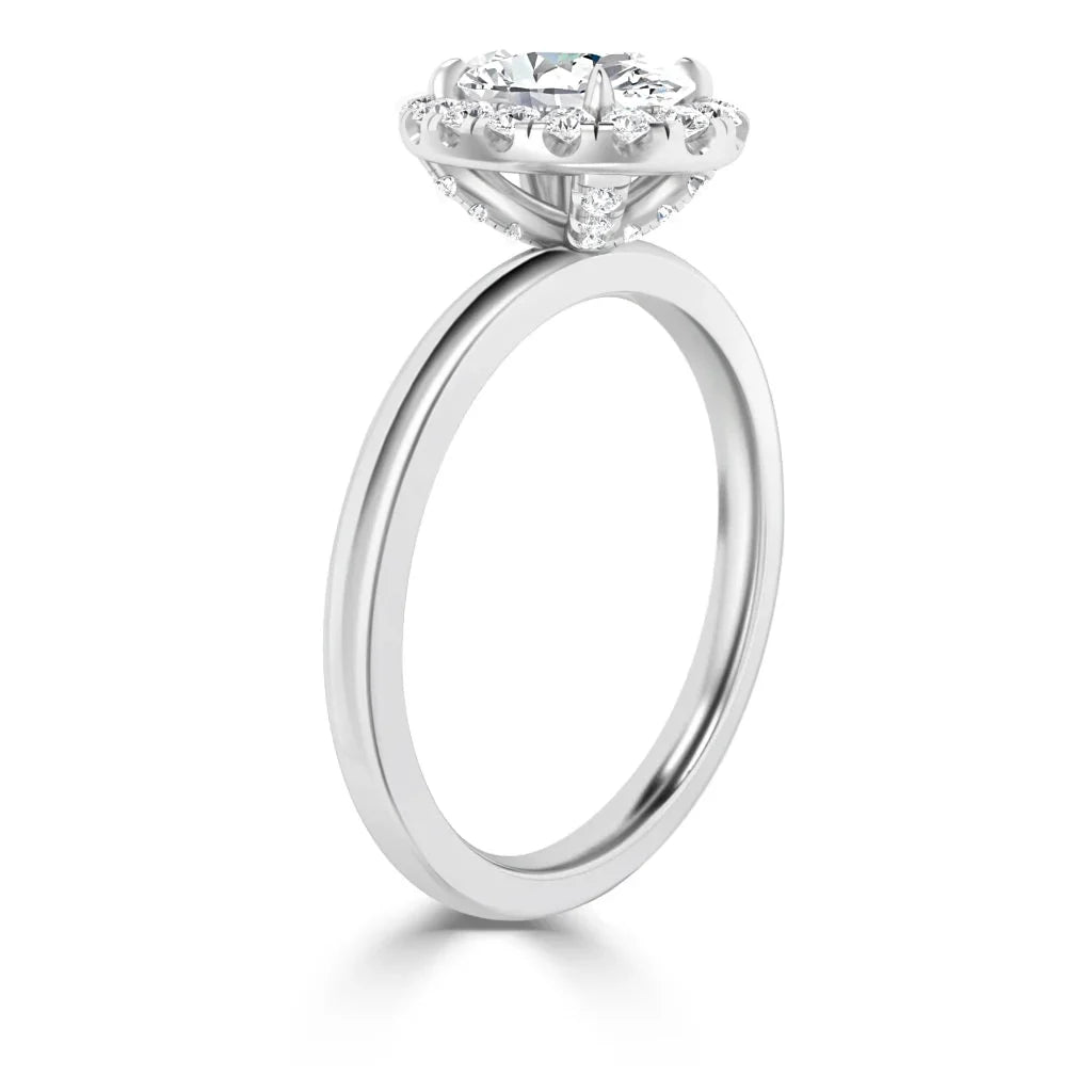 A silver engagement ring with a large round center diamond, surrounded by a halo of smaller diamonds.