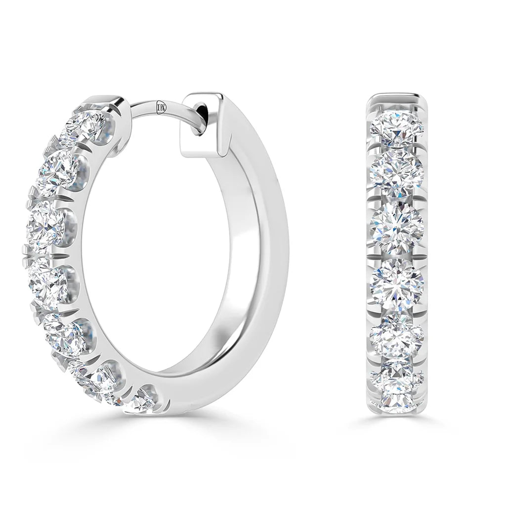 Silver hoop earrings with a row of sparkling round-cut diamonds set along the front edge.