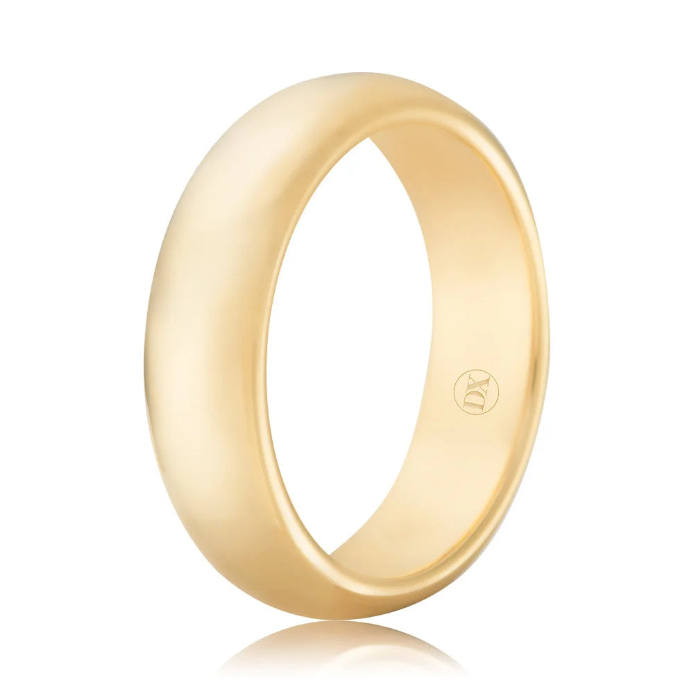 Simple gold wedding band with a smooth finish and a small stamped logo on the inner side, shown on a white background.