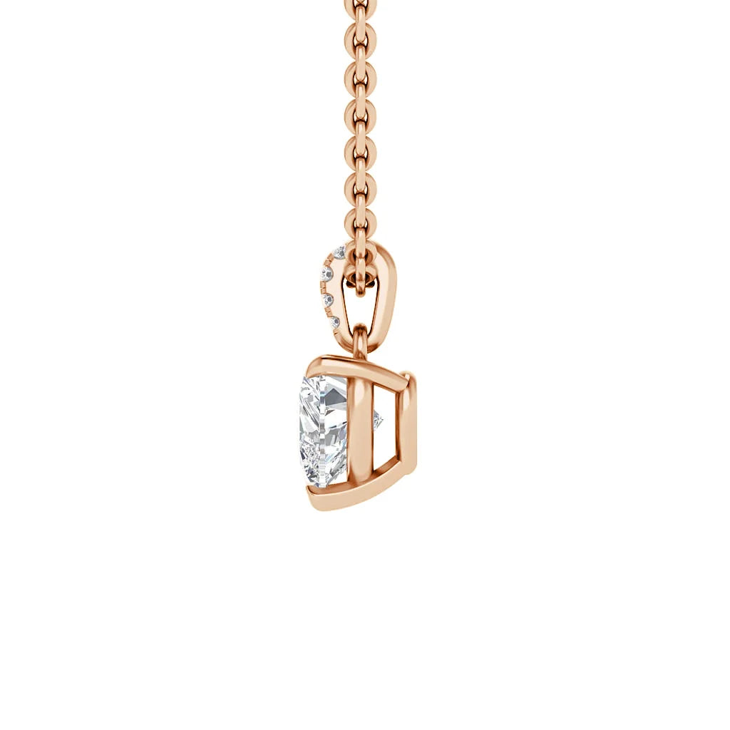 A rose gold necklace with a heart-shaped diamond pendant and a small band of diamonds on the bail.