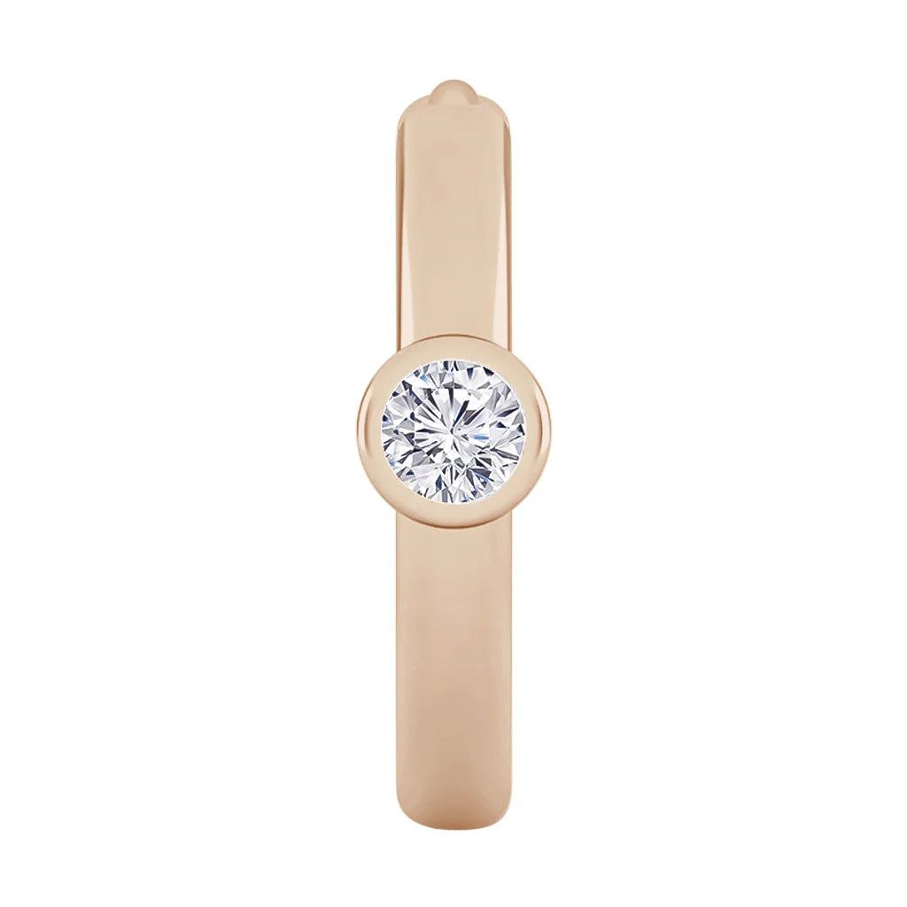A rose gold ring with a single round bezel-set diamond in the center, shown from the top view.