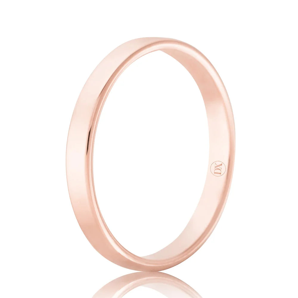 A simple, polished rose gold band ring with a smooth surface and a small engraved logo inside.