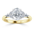 Oval diamond ring with two round and two marquise diamonds on a yellow gold band, viewed from the front.