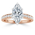 Rose gold ring with marquise-cut diamond center and round diamonds on the band, on white background.
