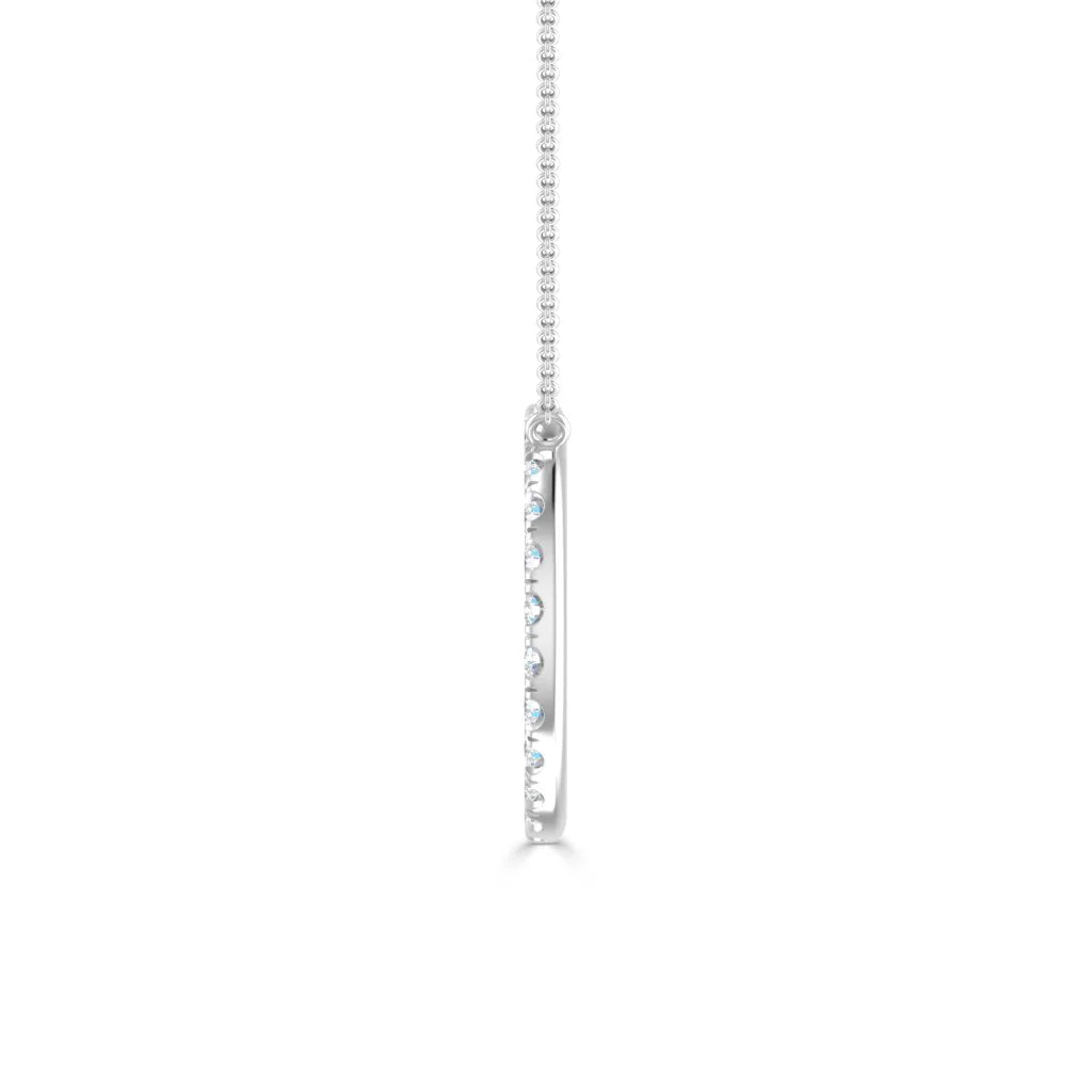 Side view of a thin silver pendant necklace with inset small round gemstones, on a fine chain, against white background.