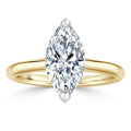A marquise-cut diamond solitaire ring with a yellow gold band, viewed from the front on a white background.