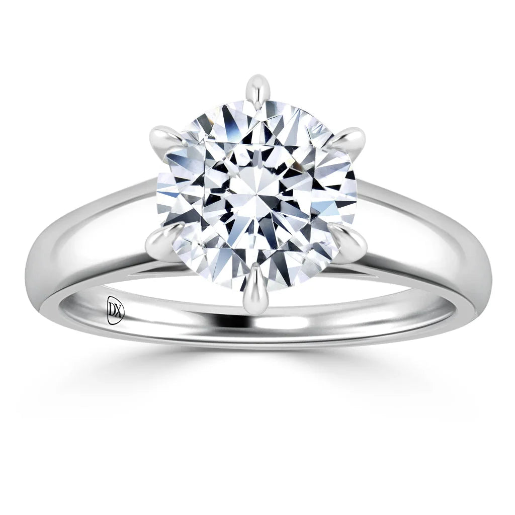 A round brilliant diamond solitaire on a polished white gold band with six prongs holding the stone.