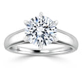 A round brilliant diamond solitaire on a polished white gold band with six prongs holding the stone.