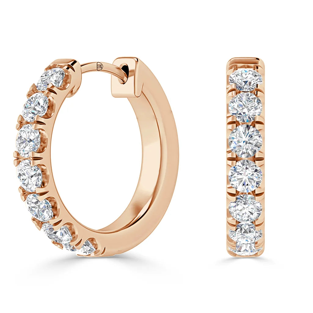 Rose gold hoop earrings with a row of round white diamonds set along the front and outer edge.