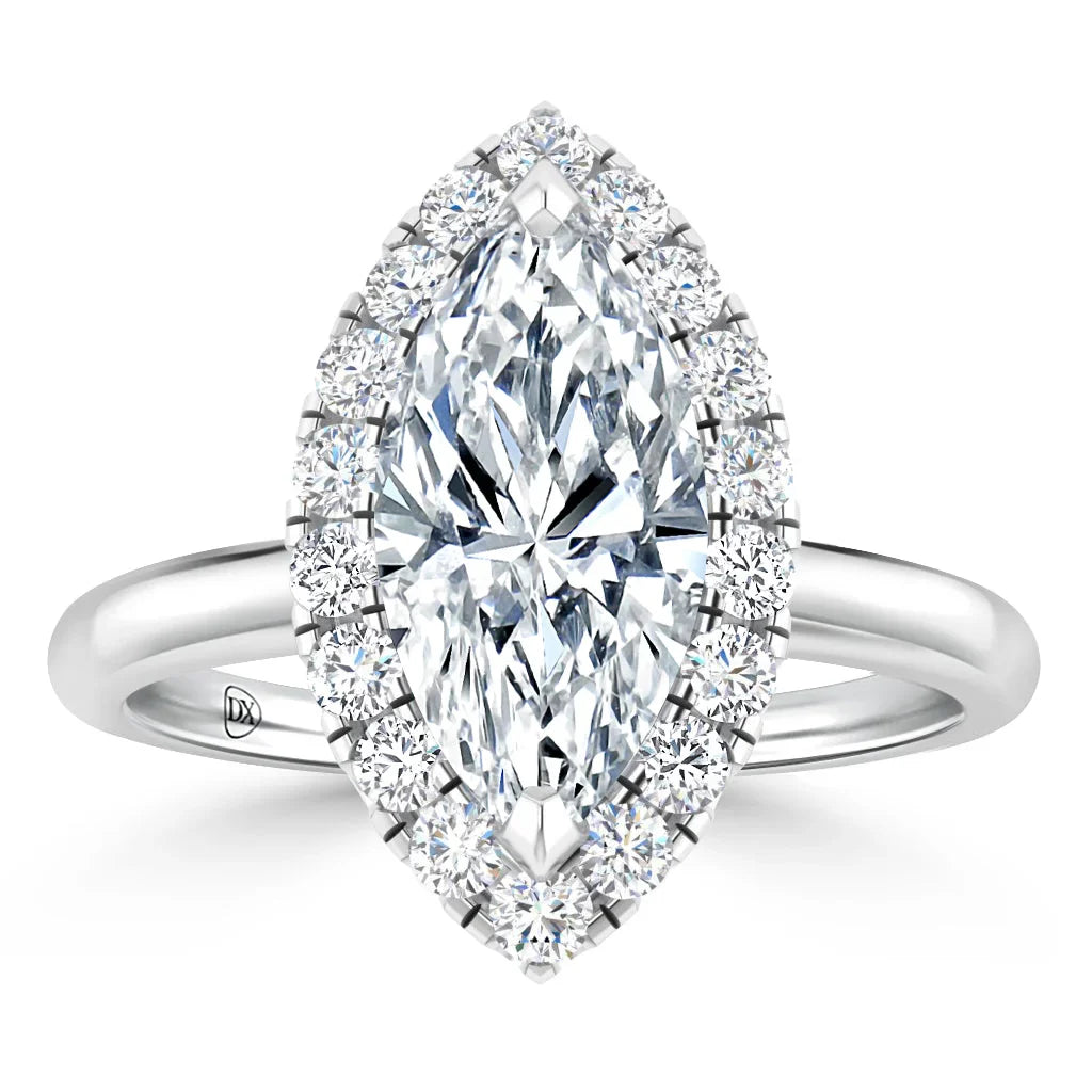 A marquise-cut diamond ring with a halo of smaller diamonds on a polished silver band.