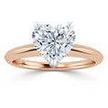 Rose gold ring with a large heart-shaped diamond held by three prongs, viewed from the front.