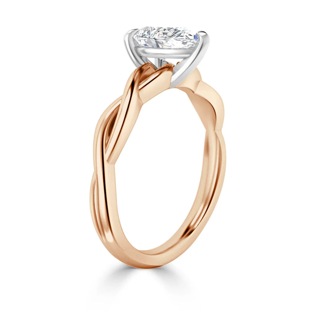 Rose gold ring with an intricate twisted band and a single round diamond solitaire in a prong setting.
