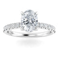 Oval-cut diamond ring with a pavé diamond band set in white gold, shown on a white background.