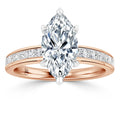 Rose gold ring with a marquise-cut diamond center and channel-set diamonds along the band.