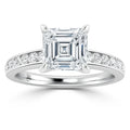 A platinum ring with an Asscher-cut diamond center stone and smaller diamonds set along the band.