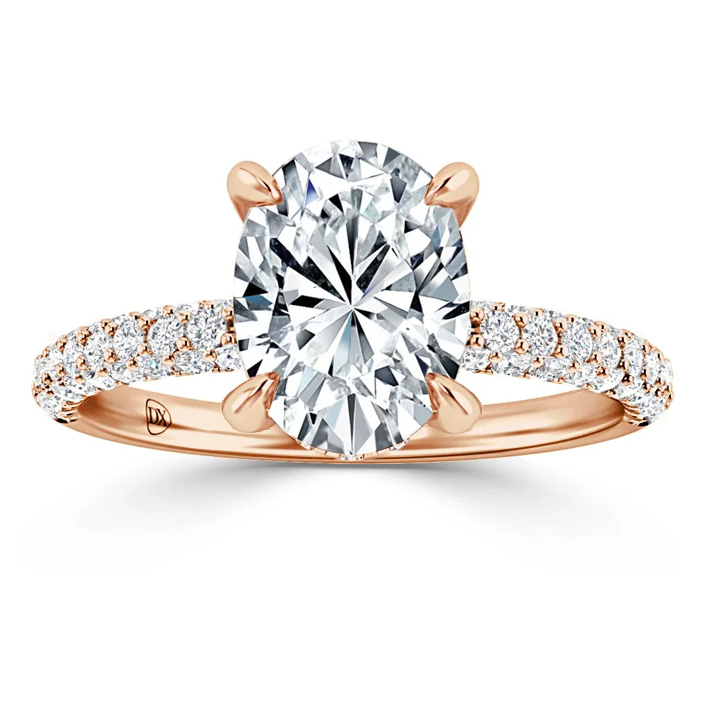 Oval diamond ring with rose gold band, pavé-set with small diamonds, shown on a white background.