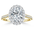 Gold ring with an oval-shaped diamond center, a halo of smaller diamonds, and a diamond-studded band.