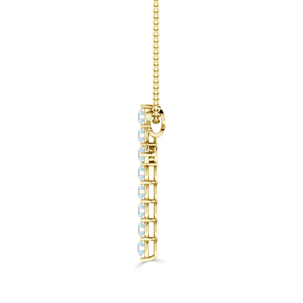 Gold vertical pendant with a row of sparkling diamonds, hanging from a delicate gold chain, on white background.