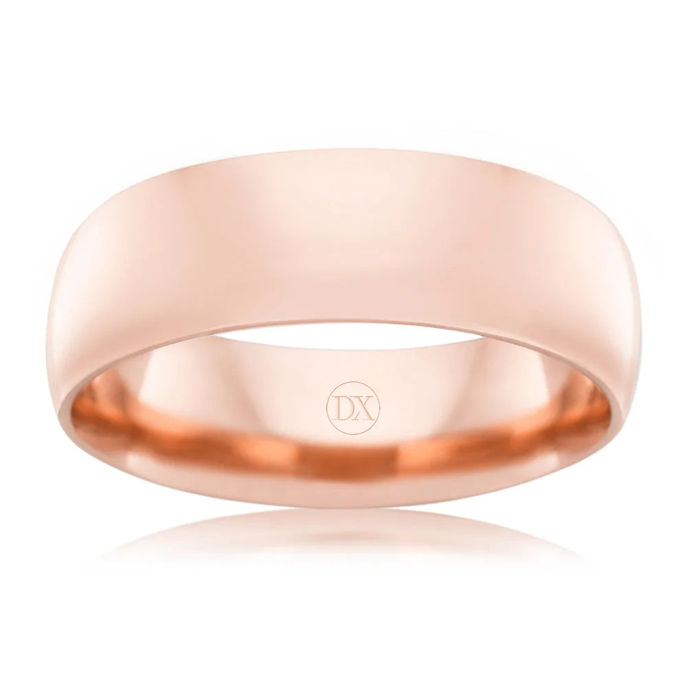 A plain, polished rose gold band ring with a subtle DX engraving inside, shown on a white background.