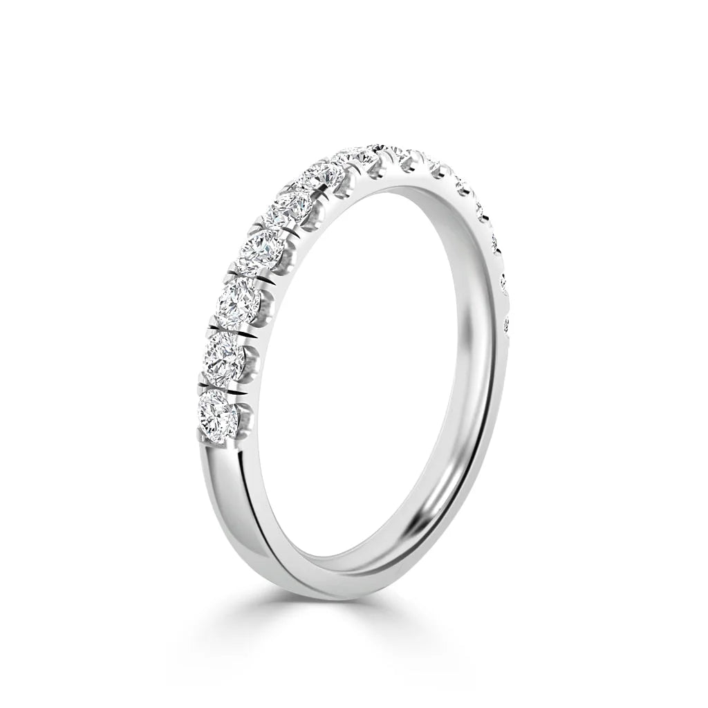 White gold ring with a row of round-cut diamonds set along the upper half of the band, on a white background.