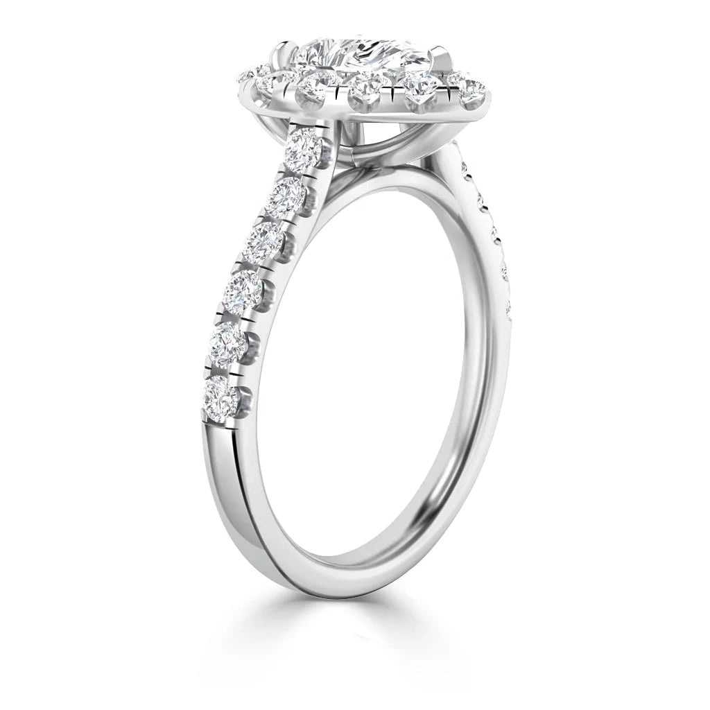 White gold engagement ring with round center diamond and pavé diamonds along the band and halo setting.