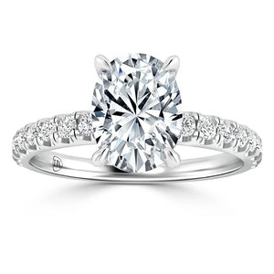 Platinum ring with an oval-cut diamond center stone and round diamonds set along the band.