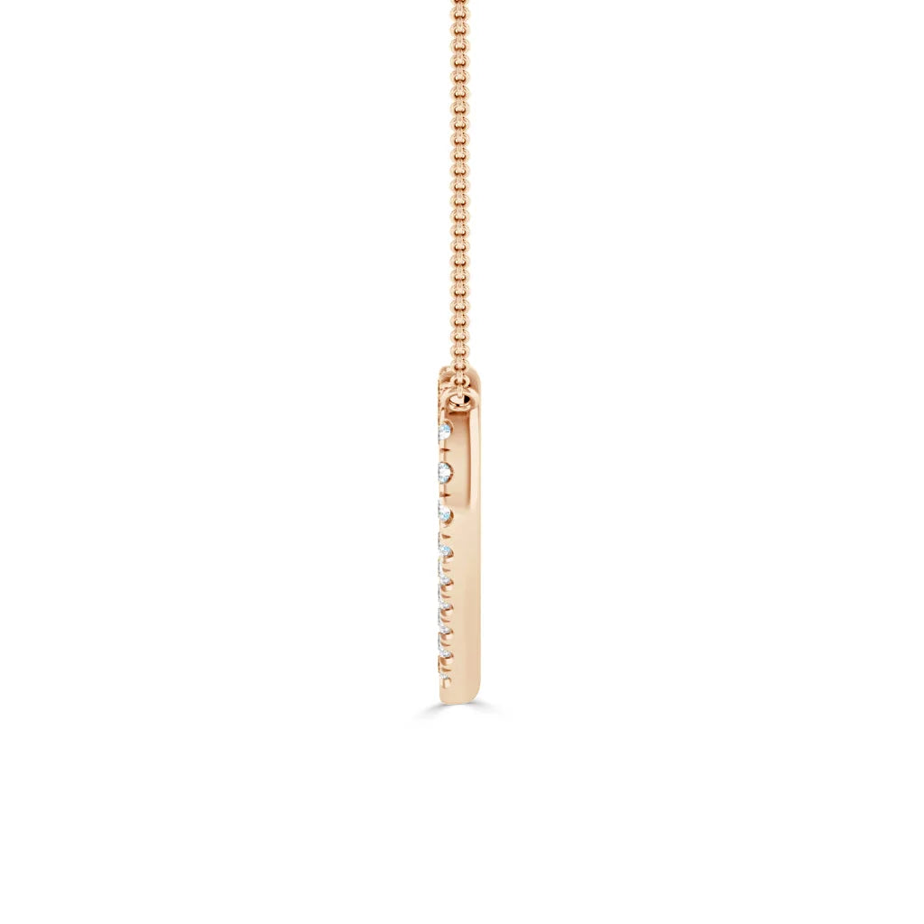A gold chain with a vertical, slim gold bar pendant studded with small diamonds along one side.