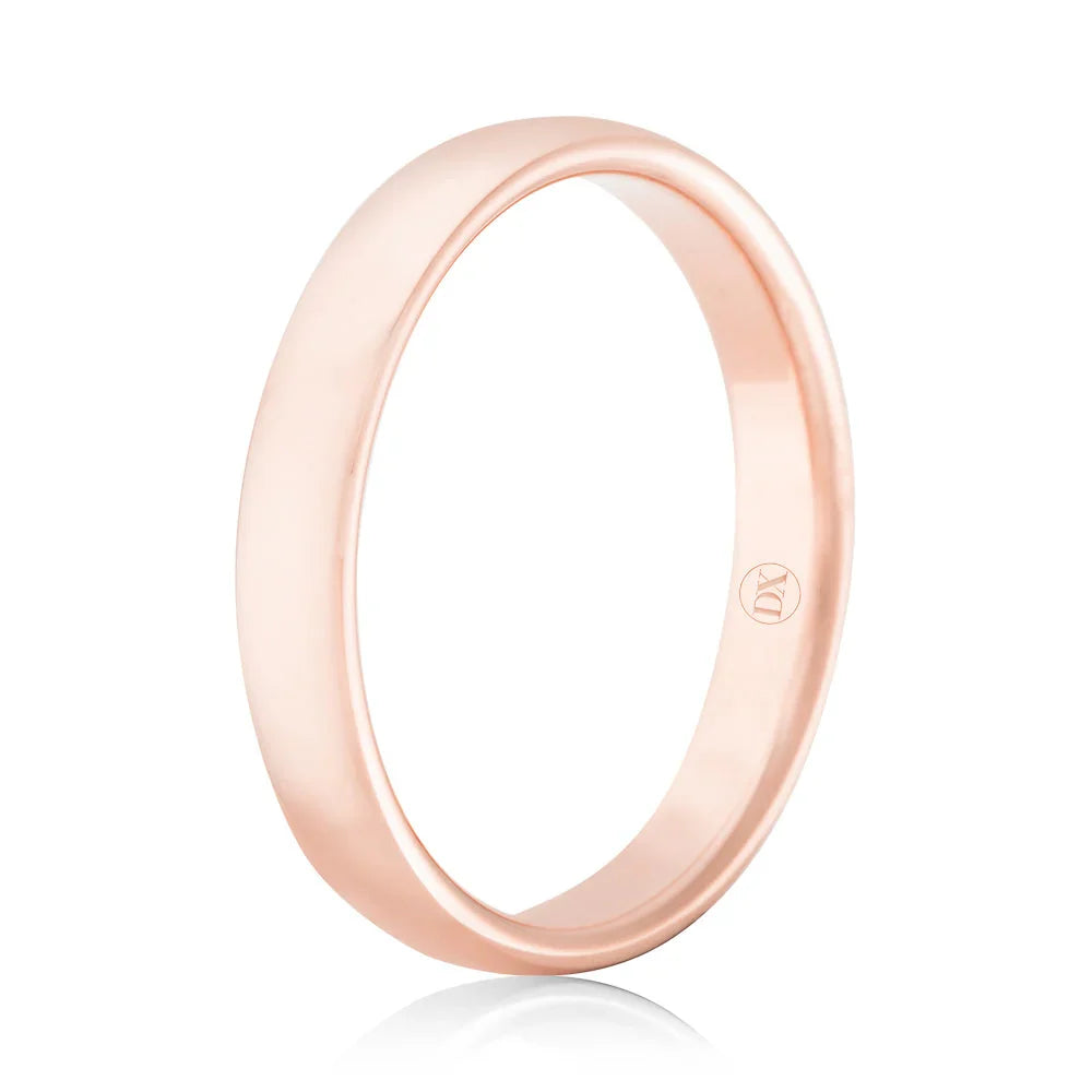A simple, polished rose gold ring with a smooth finish, viewed from a slight side angle on a white background.