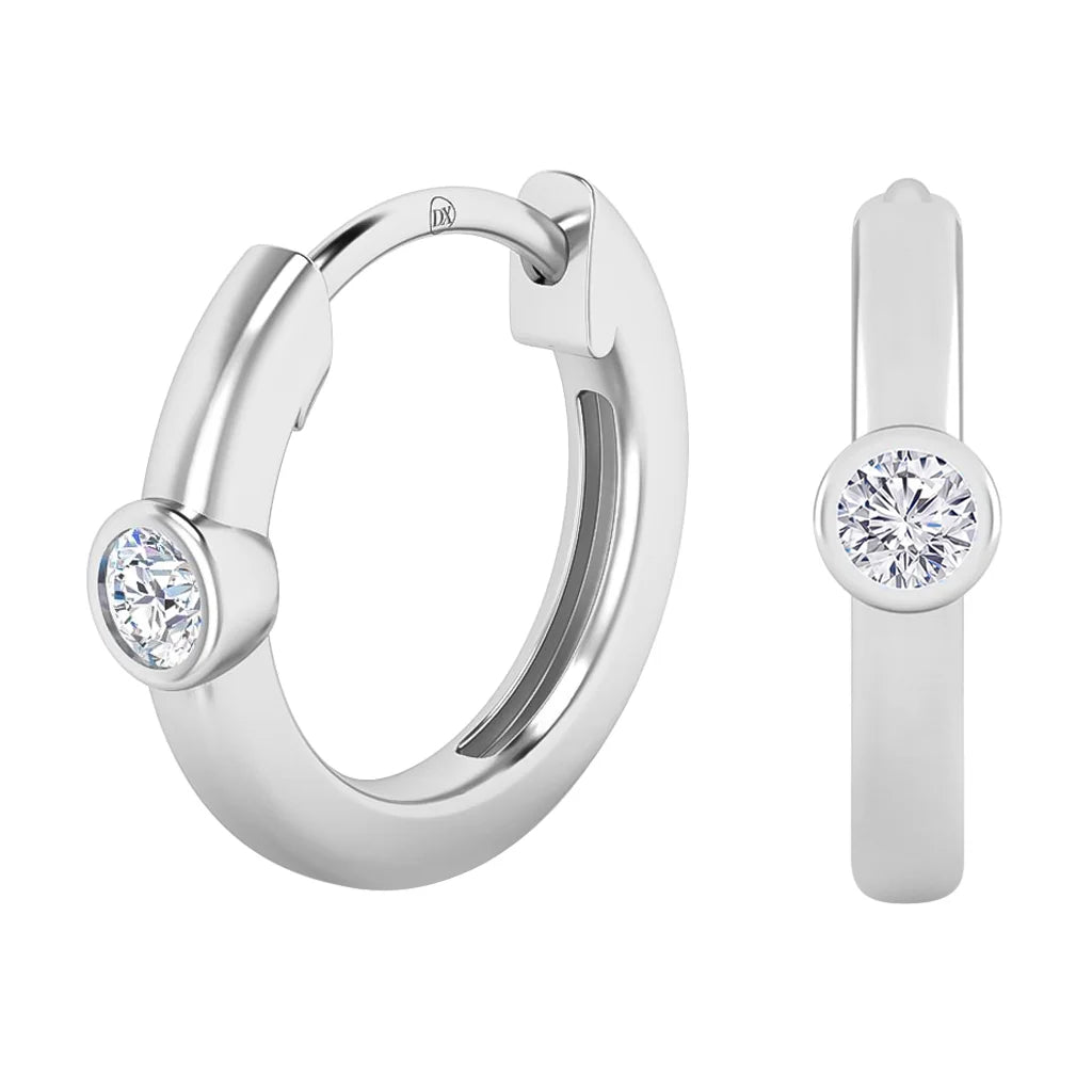 A pair of silver hoop earrings, each set with a single round clear gemstone in a bezel setting.