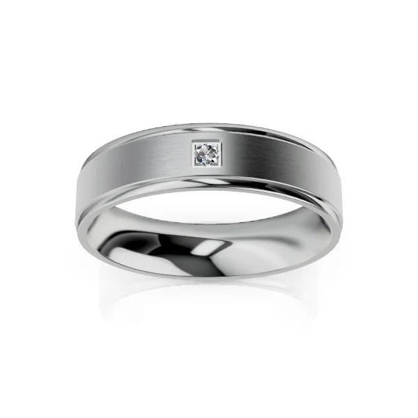 A silver ring with a brushed finish and a single small square-set diamond in the center.