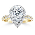 Gold ring with a large pear-shaped diamond center, haloed by smaller diamonds, and a pavé diamond band.