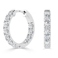 White gold hoop earrings, each encrusted with a row of round sparkling diamonds on the outer surface.