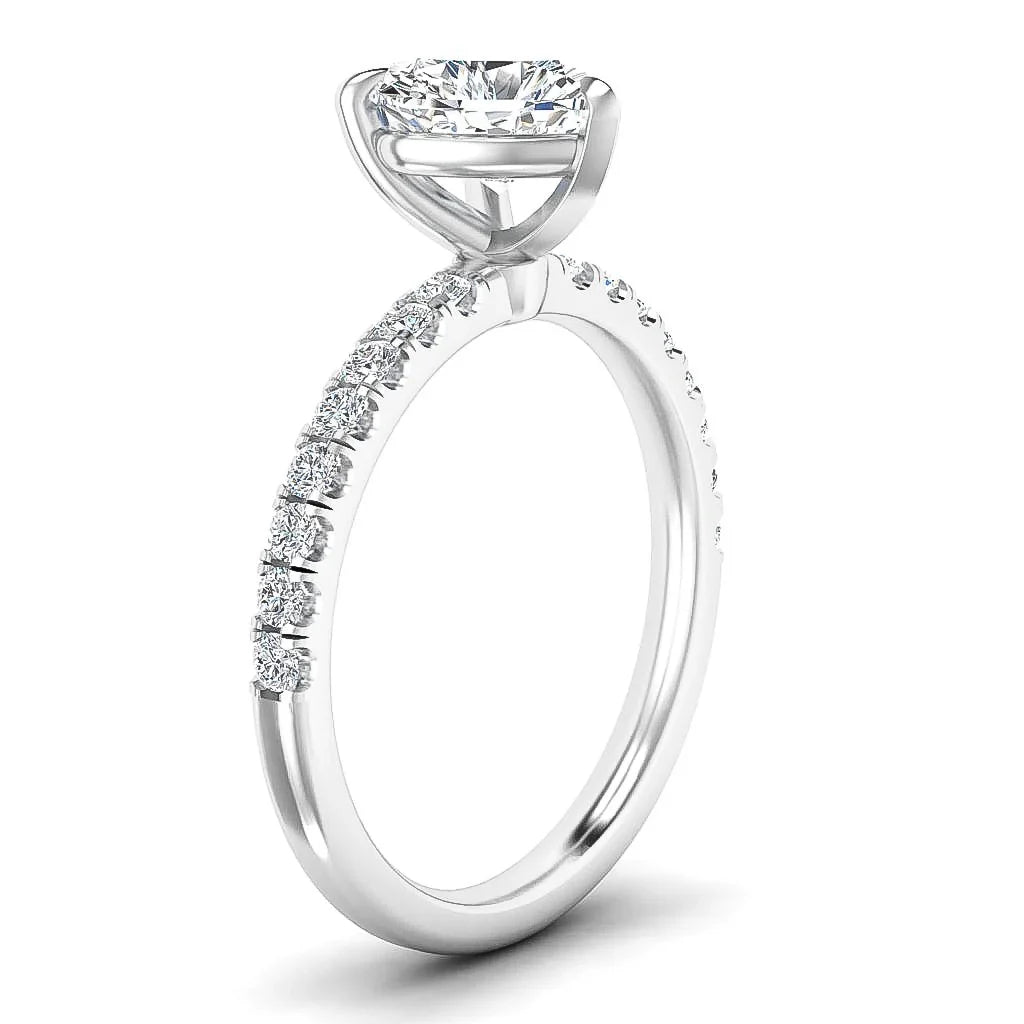 A white gold engagement ring with a round solitaire diamond and small diamonds set along the band.