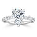 Pear-shaped diamond ring with a pavé diamond band set in white metal, shown on a white background.