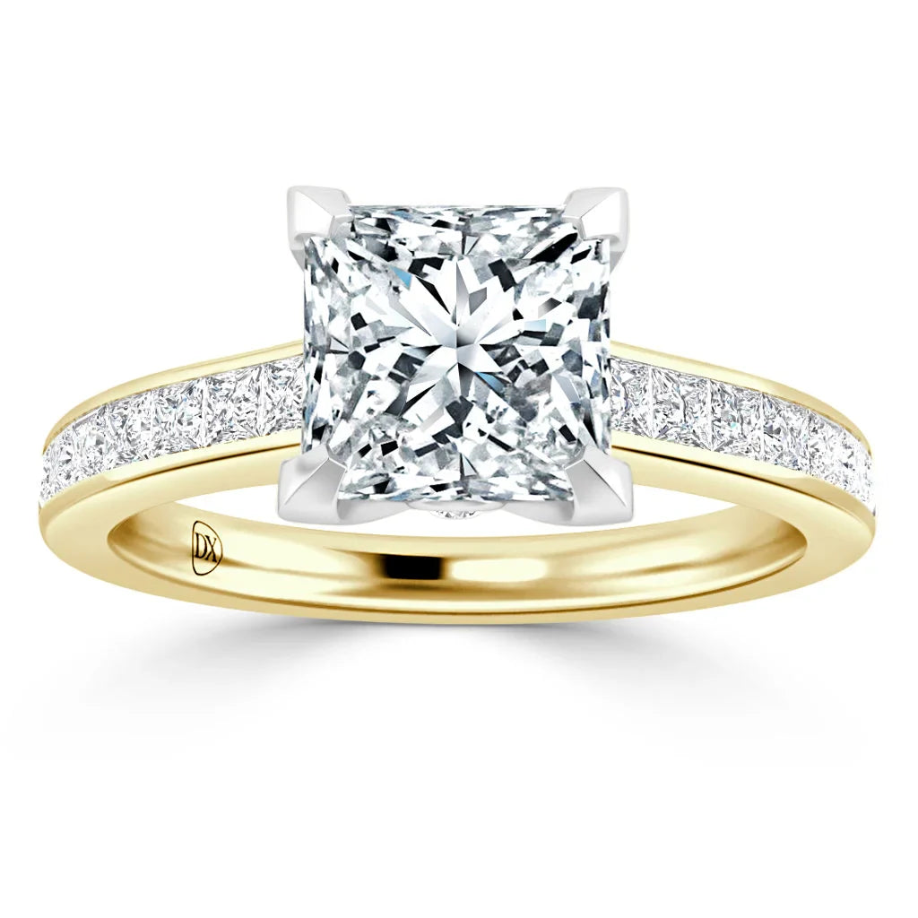 Gold ring with a large square-cut diamond and smaller diamonds set along the band.