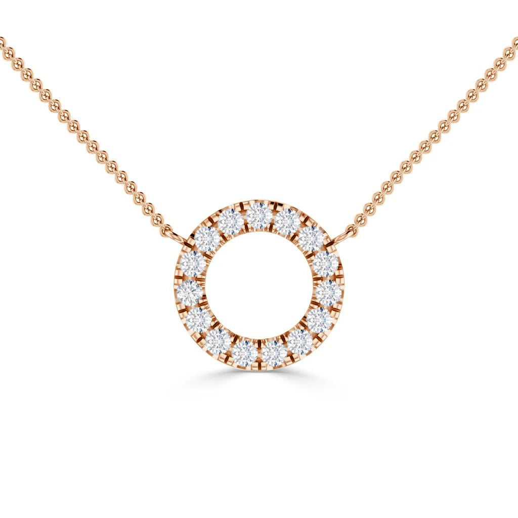 Rose gold necklace with a circular pendant encrusted with small sparkling diamonds on a fine chain.