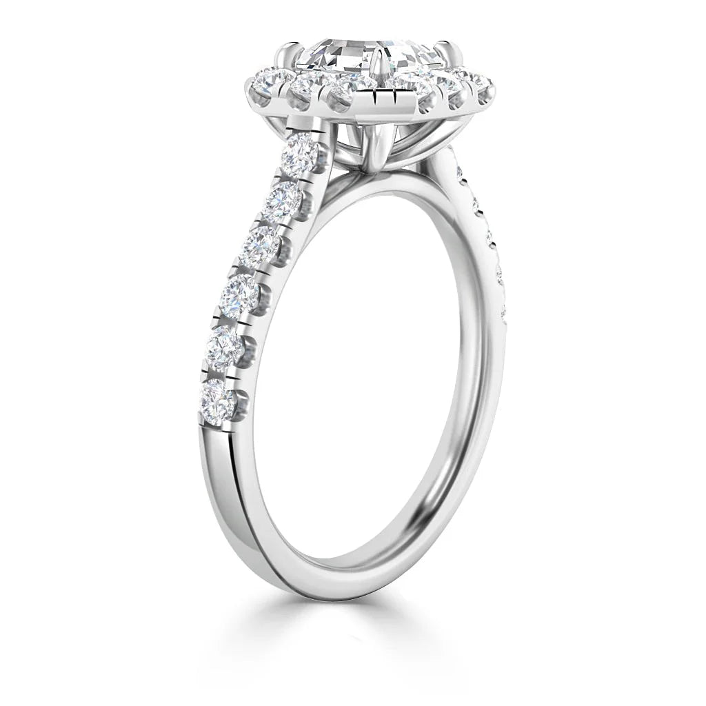 White gold ring with a large round center diamond and smaller diamonds along the band and halo setting.
