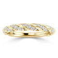 A gold ring with intertwined bands, adorned with small round diamonds along the twisted design.