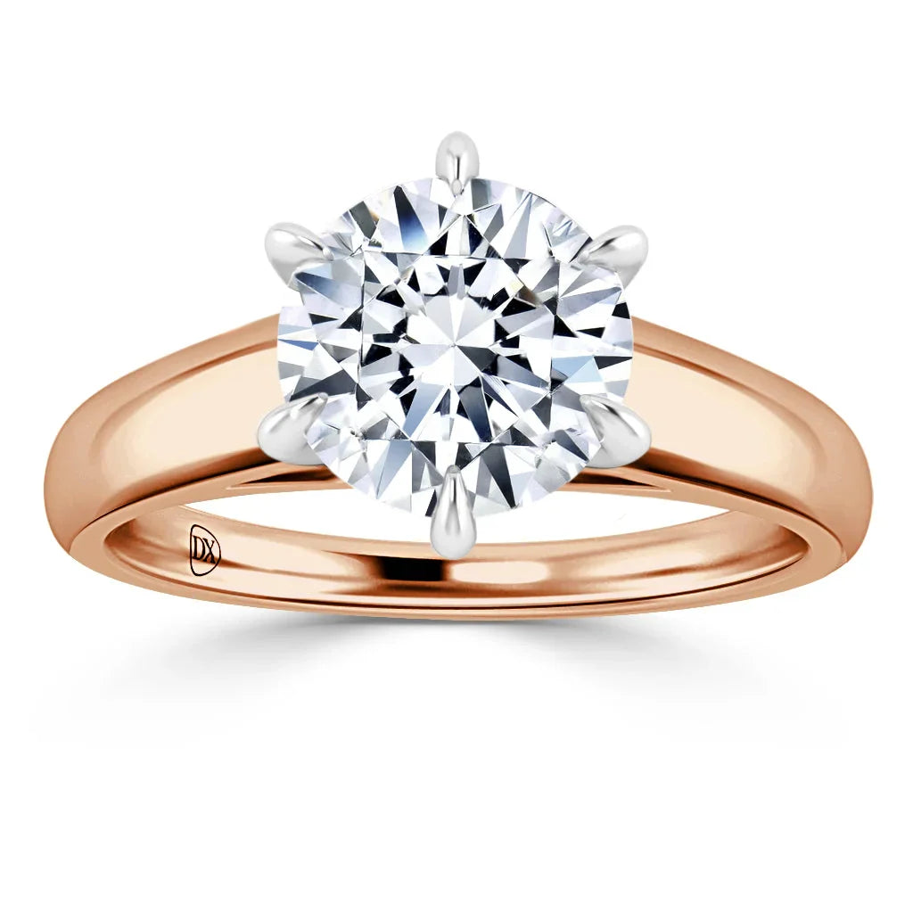 A round diamond solitaire ring with six prongs on a rose gold band, viewed from the front.